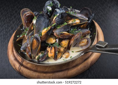 seafood mussels on pan with cream sauce. restaurant food 