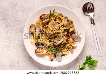 Seafood pasta with clams Spaghetti alle Vongole on a light background. Top view