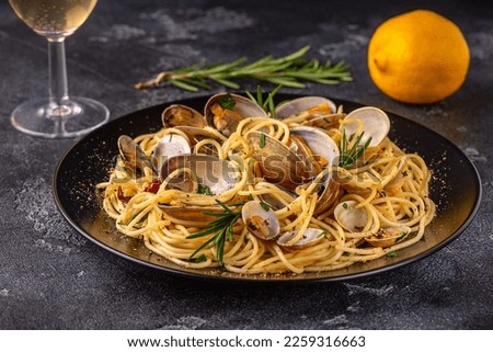 Seafood pasta with clams Spaghetti alle Vongole on a dark background.