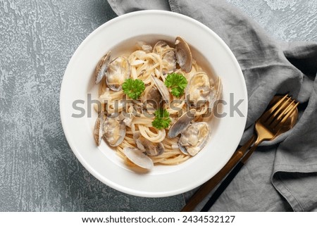 Seafood pasta with clams. Spaghetti alle Vongole on a light background. Top view