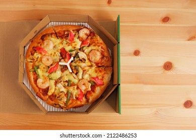 Seafood Pizza With Shrimp And Crab Stick And Mozzarella Cheese  Isolated On Wooden Background, Food Delivery Service, Disposable Paper Food Containers