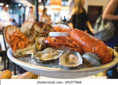 A seafood plate of delicious mediterranean catch of the day served in a famous restaurant of Barcelona - lobster, prawns, shrimps, oysters, mussels, shells, octopus and snails as a spanish dish
