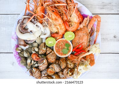 Seafood Plate With Shrimp Shellfish Crab Squid Cockle Spotted Babylon With Seafood Sauce Chili Lemon Lime Serve On Dining Table, Shrimps Prawns Seafood Buffet Menu Cooked Food