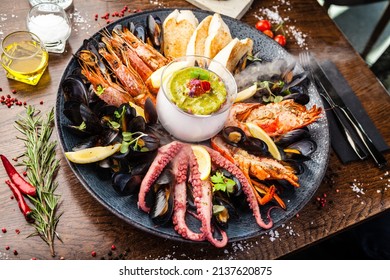 Seafood platter for 2-4 persons. Lobster, octopus, blue mussels, Argentina king prawns, tuna tartare. Delicious healthy traditional food closeup served for lunch in modern gourmet cuisine restaurant
