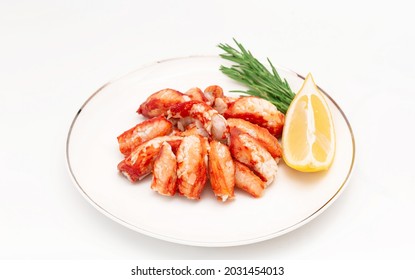 Seafood Salad With Crab Meat And Fresh Romaine Lettuce Leaves, Rosemary And Lemon On A White Plate