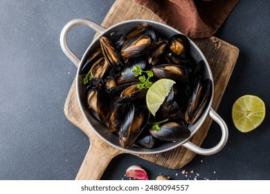 Seafood. Shellfish mussels. Baked mussels on cast iron black plate