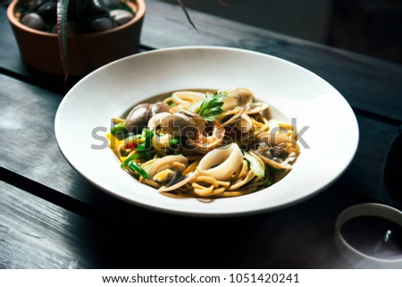 Seafood spaghetti plate on wood background