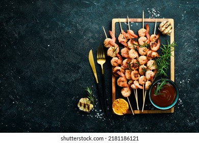 Seafood. Tiger prawns. Shrimp fried in skewers. On a stone background. Top view. - Shutterstock ID 2181186121