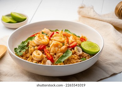 Seafood Tom Yum Fried Rice,Stir fried rice with shrimp and squid with chilli sauce on white plate - Shutterstock ID 2265541019