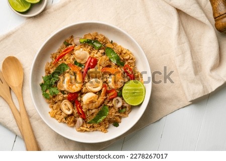 Seafood Tom Yum Fried Rice,Stir fried rice with shrimp and squid with chilli sauce on white plate.Top view Foto d'archivio © 