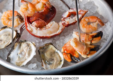 Seafood Tower. Fresh Seafood, Lobster, Crab Legs, Oysters, Shrimp, Scallops, Caviar, Clams And Octopus. Classic American Fine Dining Restaurant Appetizer.