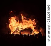 Seaford, East Sussex, England UK - October 2024: Fireworks being set of and a large bonfire ablaze during the annual event of Seaford Bonfire night.