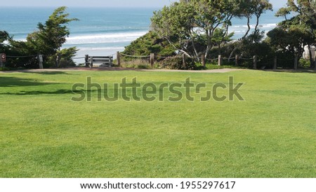 Seagrove recreation beach park in Del Mar, California USA. Seaside garden with lawn in waterfront resort. Green grass and ocean coast view from above. Picturesque coastline vista point on steep hill.