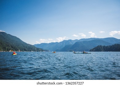 Sea-kayaking In The Calm Waters Of Deep Cove Within The North Shore Mountains Near Vancouver, BC.