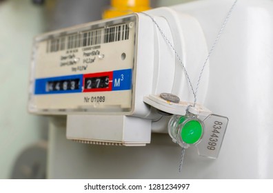 Sealed Gas Meter Hangs On Wall. Close-up.