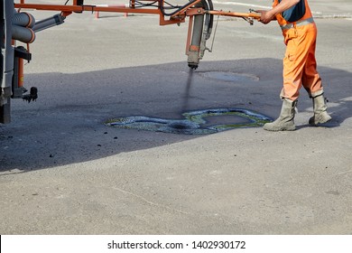 Sealing Of Asphalt Pits By Blowing Hot Mixture.