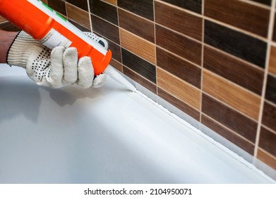 Sealing The Bathroom With Silicone Sealant. Close-up. Renovation And Decoration In The Bathroom. Sealing Seams 