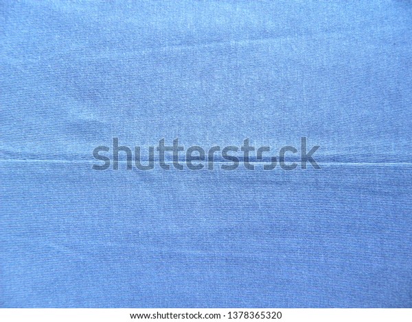 Seam on blue cotton\
fabric