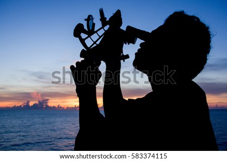 Seaman using Sextant for navigation on sunset time Silhouette.