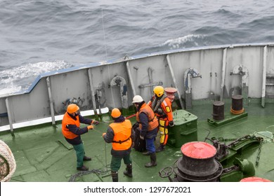 Seamen Carry Out A Rescue Operation On The Deck Of A Ship