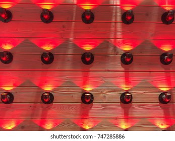 Seamless array made of shiny red light objects with same direction. Background picture.