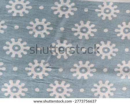 Seamless block print floral pattern on light blue cotton fabric texture, traditional ethnic motif, handcrafted textile background