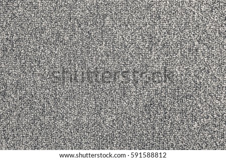 Seamless close up of monochrome grey carpet texture background from above.