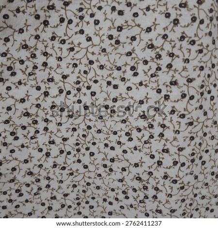 Seamless floral pattern with small dark flowers and delicate branching stems on a light fabric background. Minimalist textile design with a soft, natural aesthetic, ideal for fashion, wallpaper, and surface pattern applications.