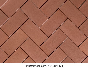 Seamless herringbone paving slabs texture in brick red