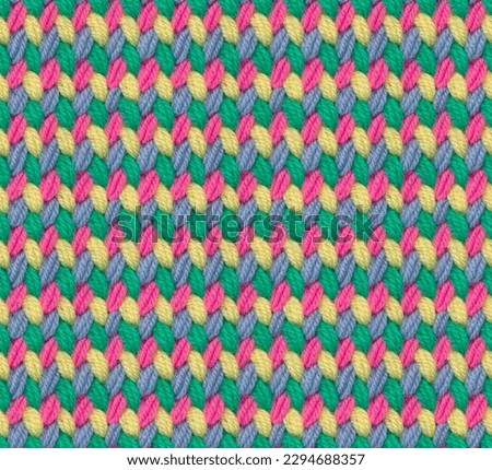 Seamless knitted pattern crocheted from bright acrylic yarn. Texture in the form of multi-colored stitches. Complementary color combination.