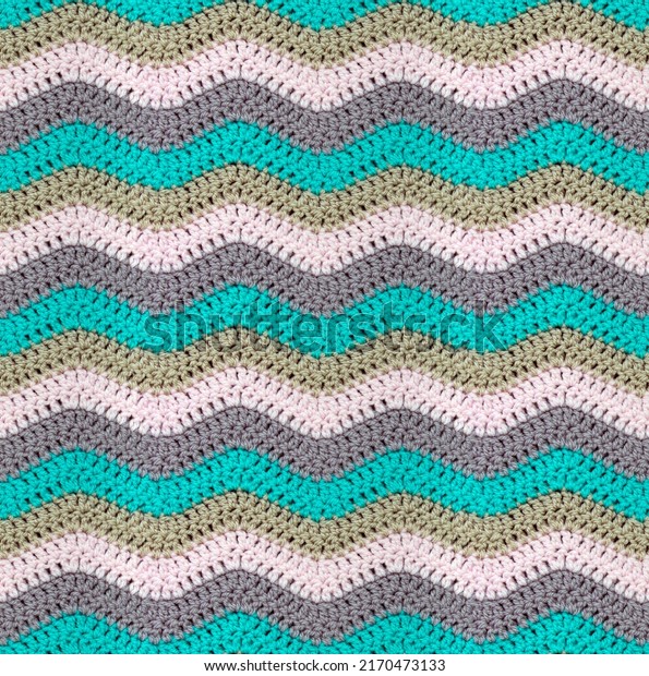 Seamless knitted pattern in the form of zigzags
is crocheted with multi-colored threads. Acrylic baby yarn. Pastel
shades.