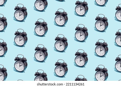 Seamless Pattern Of Black Retro Alarm Clocks  Show 2 O'clock. Changing Clock From Summer Time To Winter Time. Shifting The Clock Hands Back In Autumn.