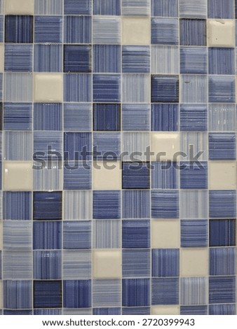 Seamless pattern of blue and white square mosaic tiles. Textured ceramic surface for swimming pool, bathroom, or kitchen backsplash design.
