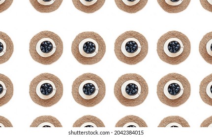 Seamless pattern with blueberries in a cup and on a saucer and jute napkin and texture background, flat lay. Healthy eating concept. - Powered by Shutterstock