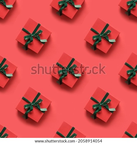 Seamless pattern of Christmas red gifts with green ribbon on red background. Xmas abstract texture for wrap paper for greeting card, flyer, coupon.