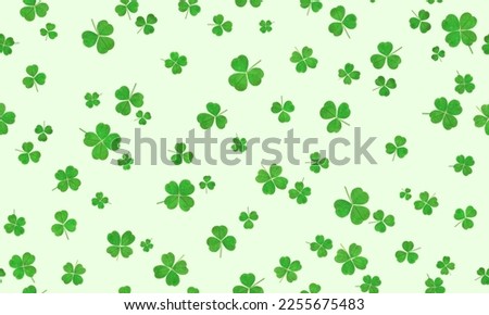 seamless pattern of clover leaves on a light background