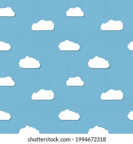 Seamless pattern. Cute clouds pattern on a blue paper background.  - Powered by Shutterstock