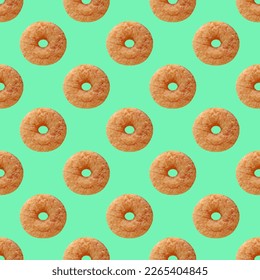 Seamless Pattern of Delectable Cinnamon Doughnut on Mint Green Colored Background Stockfotó