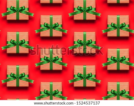Seamless Pattern Gift boxes with green ribbon on red background top view flat lay. Holiday concept, new year Christmas gift, presents birthday valentine's day Xmas. Congratulations Festive background
