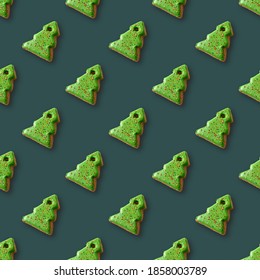 Seamless pattern of gingerbread in shape decorative Christmas tree on green background. Xmas holiday abstract background. - Powered by Shutterstock