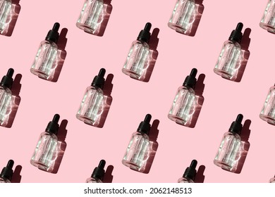 Seamless Pattern Of Liquid Oil Serum Bottle Isolated On Pink Background. Retinol, Aha, Bha Acid, Collagen Skincare Fluid In Glass Vial. Gel Essence In Dropper For Beauty Treatment, Cosmetic Backdrop.