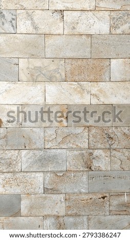Seamless pattern of modern light beige and gray natural stone brick wall, clean rectangular stone tiling surface texture background for architectural exterior decoration design.