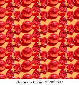 Seamless Pattern With Red Wrapped Candy On Yellow Background.