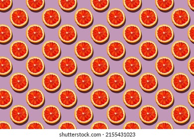 Seamless Pattern With Round Slices Of Blood Orange On A Soft Lilac Background, Pop Art Style Of The Sixties