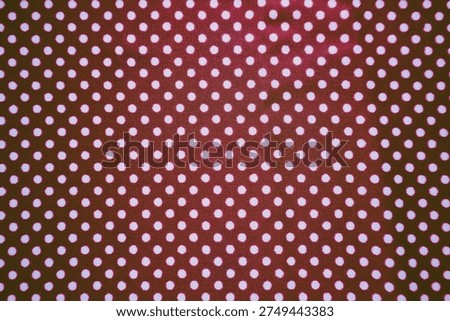 Seamless pattern of small white dots on a dark purple or maroon textile surface. Classic polka dot design suitable for fashion, craft, or decorative backgrounds.