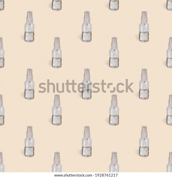 Seamless pattern of transparent sprayers\
filled on half liquid on a yellow\
background