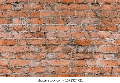 Seamless red brick pattern. Old brick wall with cracks and scratches. Horizontal wide brickwall background. Distressed wall with broken bricks texture. Vintage house facade.