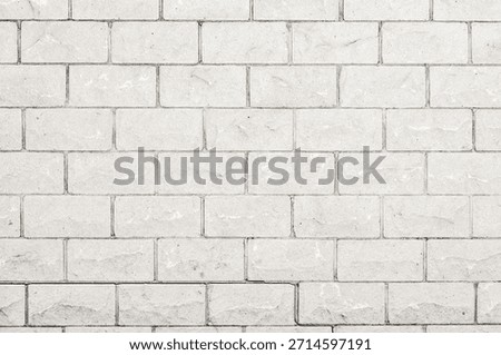 A seamless, repeating pattern of light grey bricks with a rough, natural texture and thin, dark grey grout lines