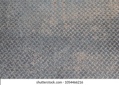 Seamless Sheet Of Steel Aluminum Or Nickel Tread Plate. Dirty Grunge Background Pattern With Dirt And Grime. Worn Piece Of Metal.