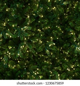 Seamless Texture Of Christmas Tree Decorated With Warm LED Garland. New York. USA.